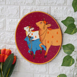 Load image into Gallery viewer, Crafted on a wooden plate, this pichwai portrays three cows in a circular formation.