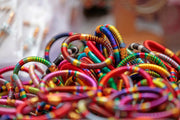 A pile of colorful bracelets sitting on top of a table