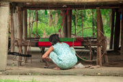 Woman working at a traditional loom