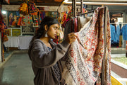 Woman examining fabric at an outdoor market