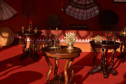 Antique display with ornate tables and artifacts.