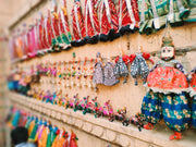 Colorful puppets displayed on a wall