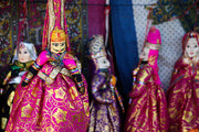 Traditional indian puppets in colorful embroidered dresses