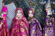 Four traditional indian puppets in ornate clothing