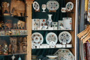Marble decorative items with floral inlay designs on display
